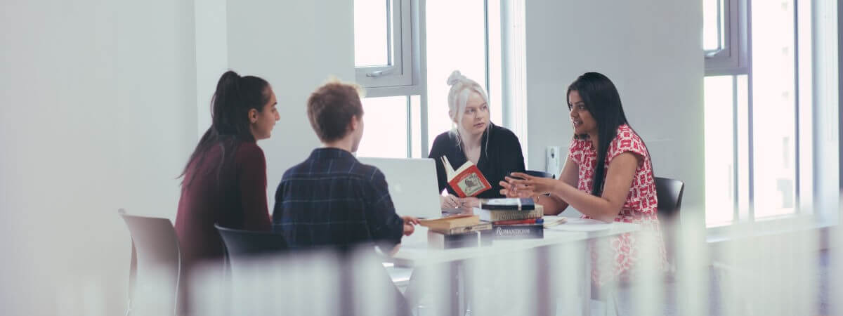 A group of students talking at a table
