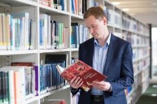 Staff member browsing a book