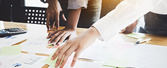 Funded Projects 341x139 - People looking at documents