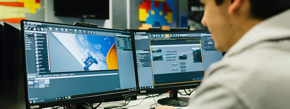 Student working with two computer screens