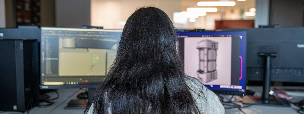 Student working on two computer screens