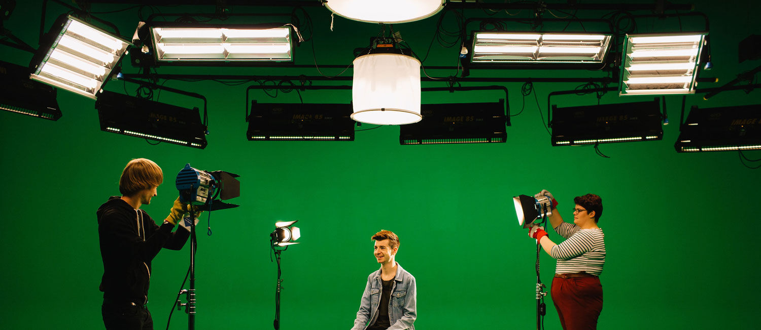 Students taking photos in the green screen room