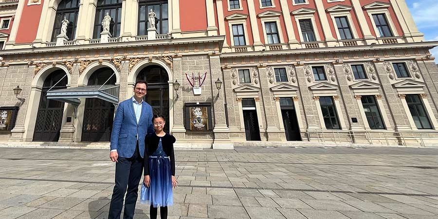 Jan Loeffler and Aurora Chan stood outside historic building in Vienna