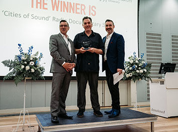 Lecturer Sam Coley receiving a Knowledge Exchange Award from Julian Beer and Ed James.