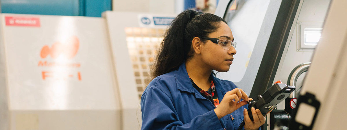 Mechanical engineering student operating machinery