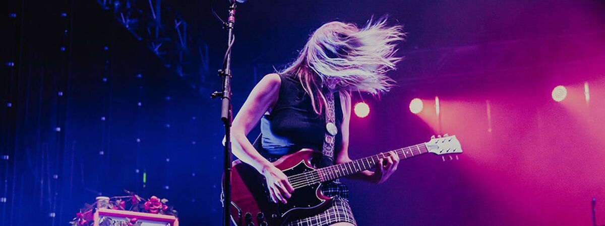 Female singer on stage with guitar