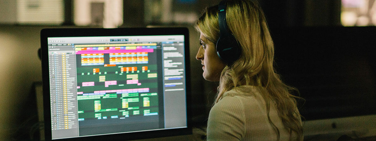 student using computer for sound engineering