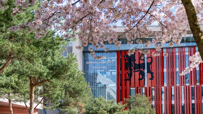 Red building with pink blossom