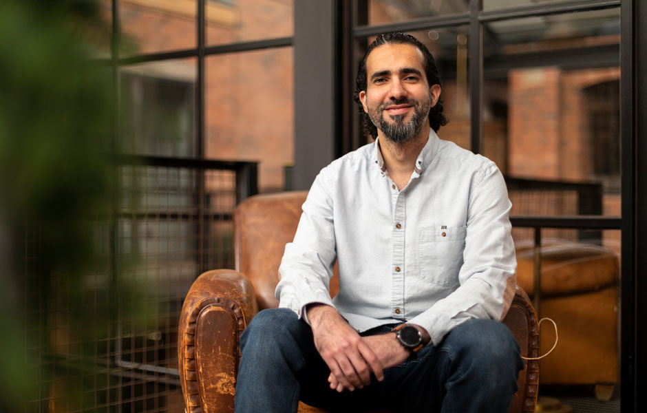 Taher smiles and looks into the camera