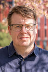 tony howe headshot stood outside Eastside Park on the BCU campus