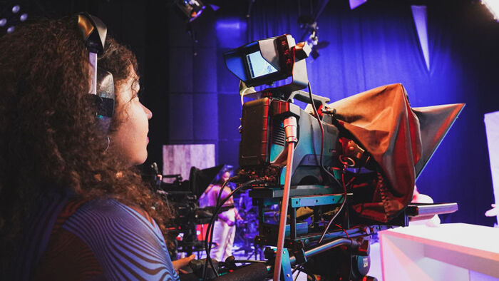 Student using an industry standard camera in our film and tv studio